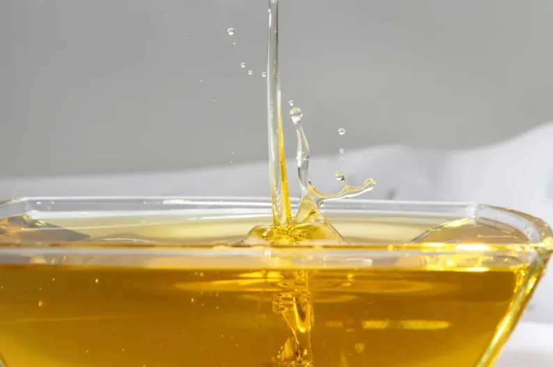 Water splashing on an oil-filled glass bowl