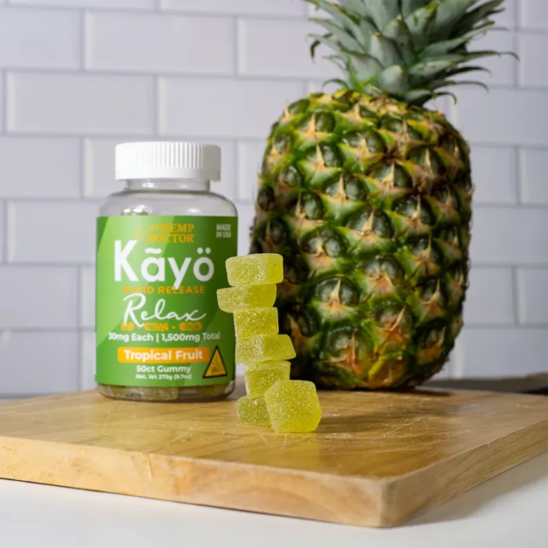 Kayo Gummies Relax Blend beside a pineapple